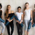 women treating pcos naturally holding yoga mats