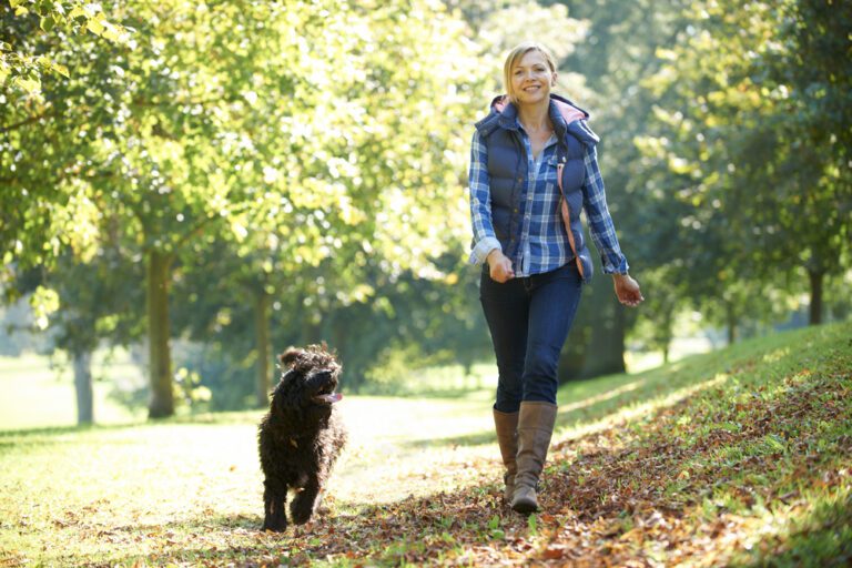 woman walking her dog to take her mind off the two week wait