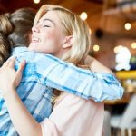 friends hugging support during infertility