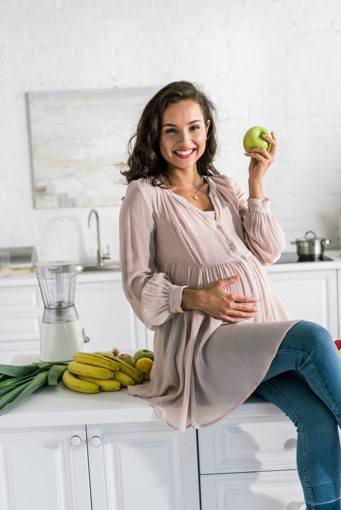 pregnant woman eating healthy foods